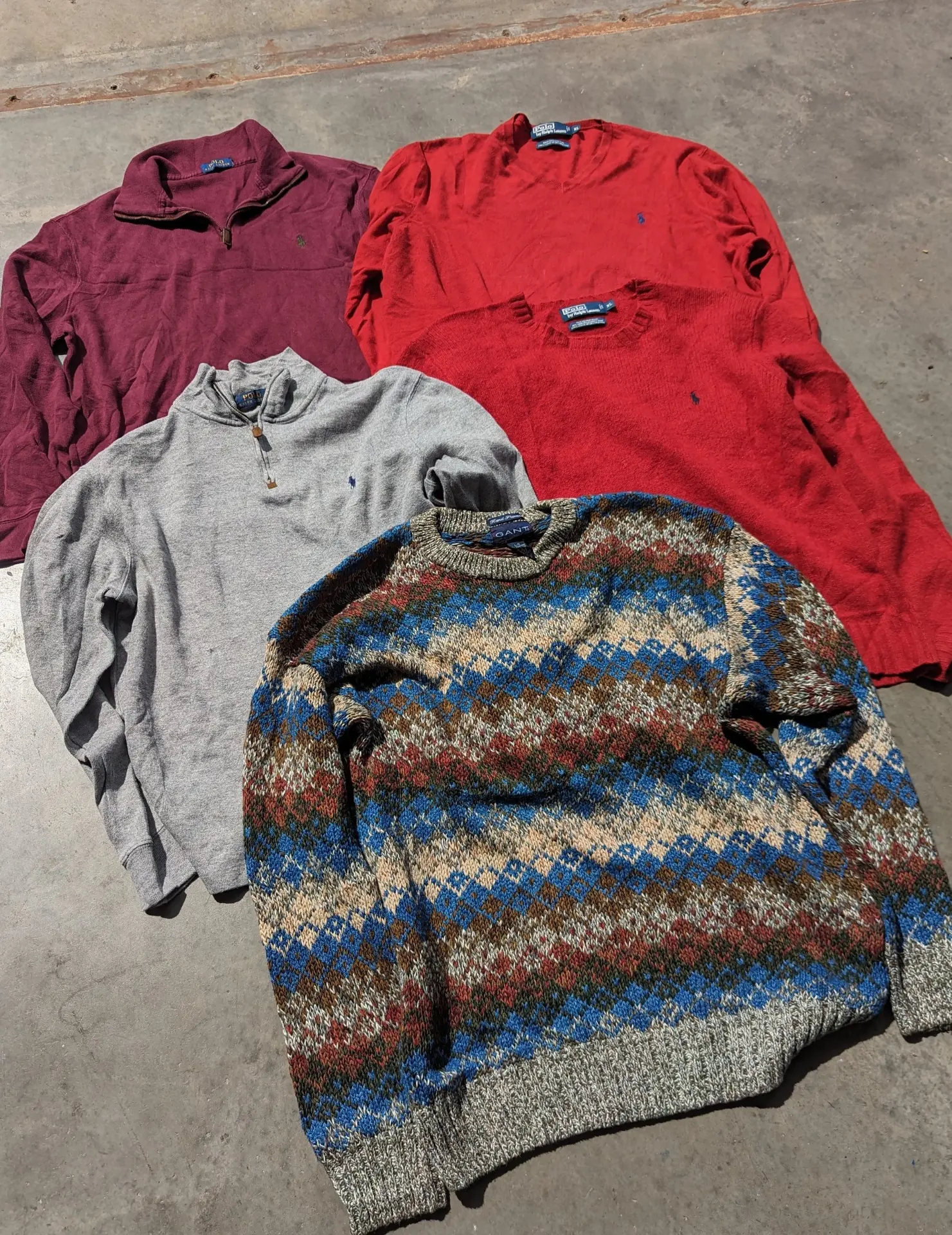 Folded Ralph Lauren knit sweaters on the WTC grading table
